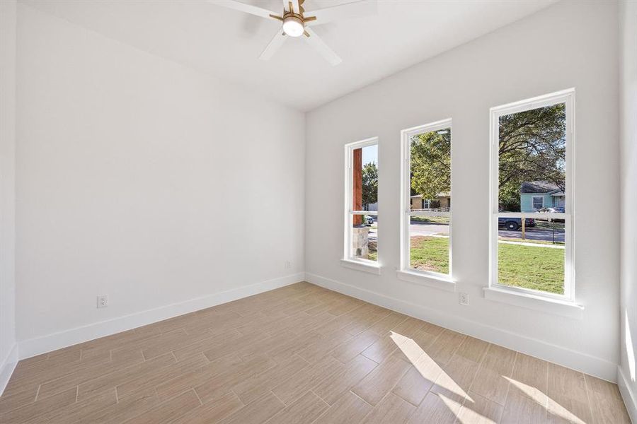 Spare room with wood finish floors and a ceiling fan
