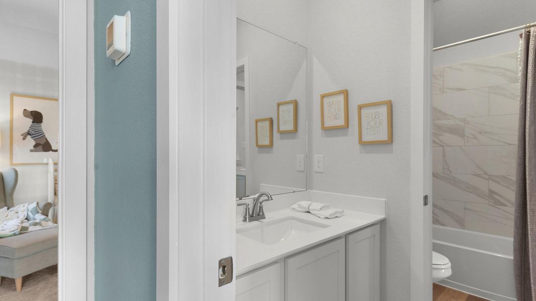 A well-appointed bathroom features a sleek vanity and a practical shower-over-tub combination. A well-appointed bathroom features a sleek vanity and a practical shower-over-tub combination.