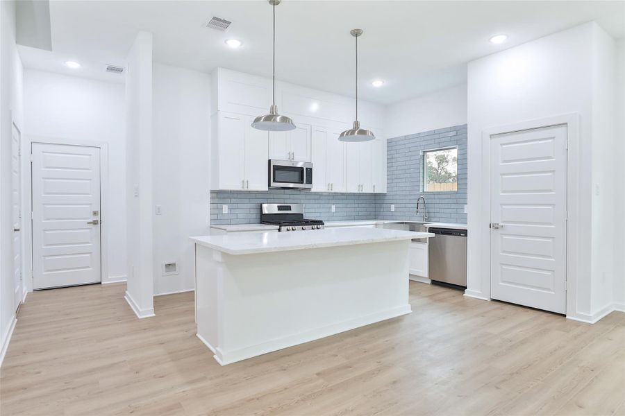 Beautiful kitchen featuring sleek Samsung stainless steel appliances. Beautiful kitchen featuring sleek Samsung stainless steel appliances.