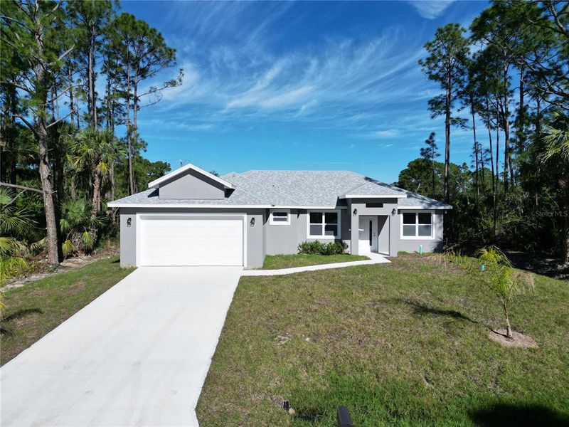 Front exterior of a new home in , Palm Bay, FL, highlighting curb appeal (Image 19).