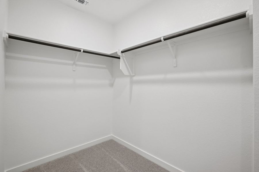 A white wall with a metal bar.