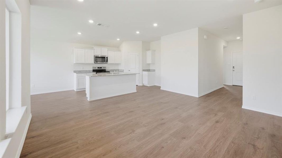 Unfurnished living room featuring light wood-style floors and recessed lighting