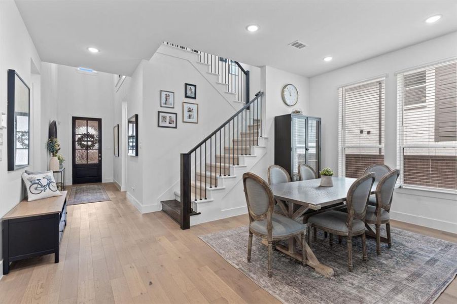 A welcoming entry with a clean look sets the tone for the home, featuring light finishes, simple lines & an airy, open feel. Note the wood floors that extend through the first floor living & dining areas + the kitchen. A welcoming entry with a clean look sets the tone for the home, featuring light finishes, simple lines & an airy, open feel. Note the wood floors that extend through the first floor living & dining areas + the kitchen.