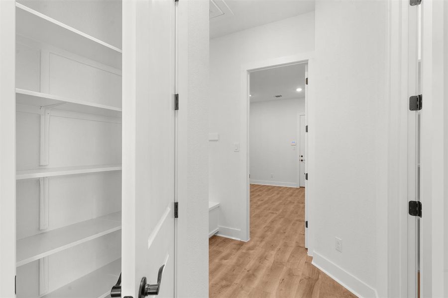 Hall with light wood-type flooring and baseboards