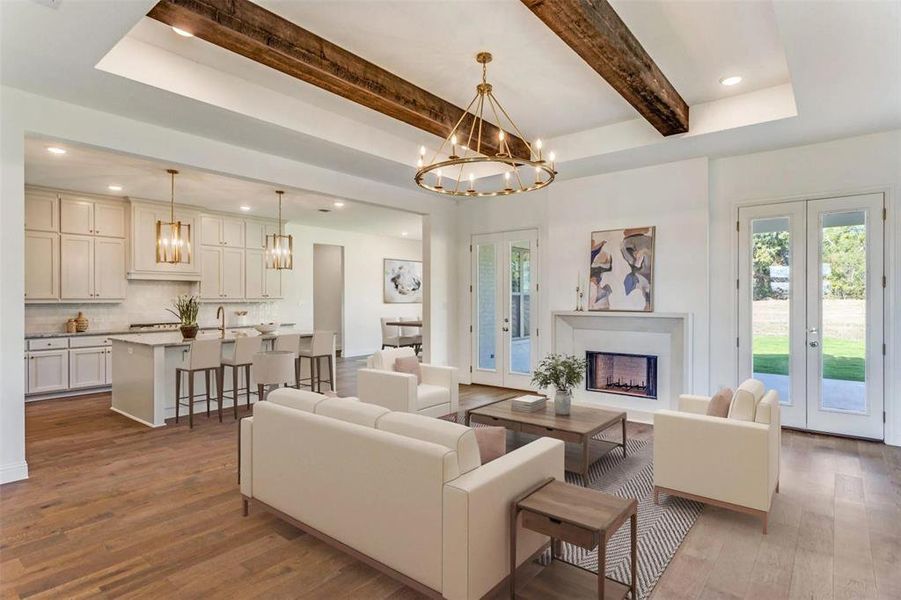 Living area with recessed lighting, french doors, a fireplace, dark wood finished floors, and healthy amount of natural light Living area with recessed lighting, french doors, a fireplace, dark wood finished floors, and healthy amount of natural light