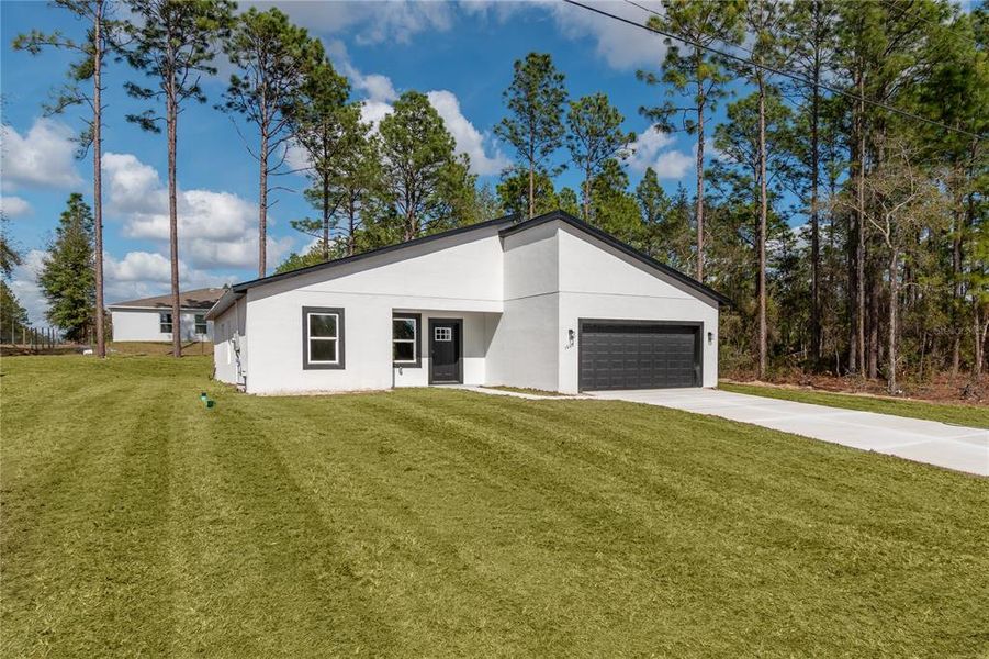 Front exterior of a new home in , Citrus Springs, FL, highlighting curb appeal (Image 28). Front exterior of a new home in , Citrus Springs, FL, highlighting curb appeal (Image 28).