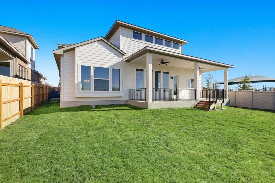 Rear view of house featuring ceiling fan and a fenced backyard Rear view of house featuring ceiling fan and a fenced backyard