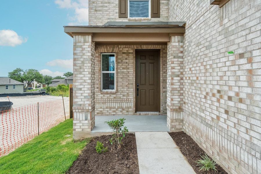 Front exterior of a new home in Creekside at Estancia, Austin, TX, highlighting curb appeal (Image 2).