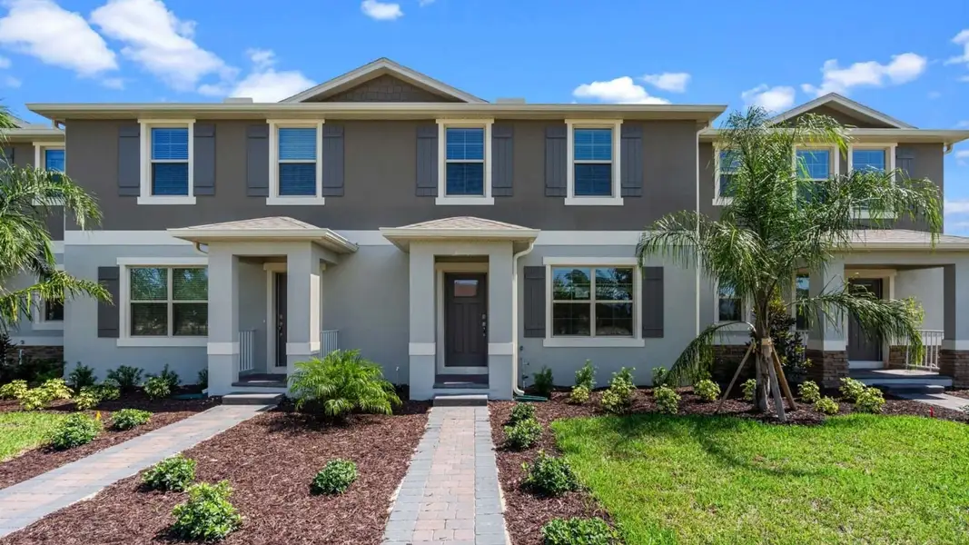 Front exterior of a new home in Waterleigh, Winter Garden, FL, highlighting curb appeal (Image 1). Front exterior of a new home in Waterleigh, Winter Garden, FL, highlighting curb appeal (Image 1).
