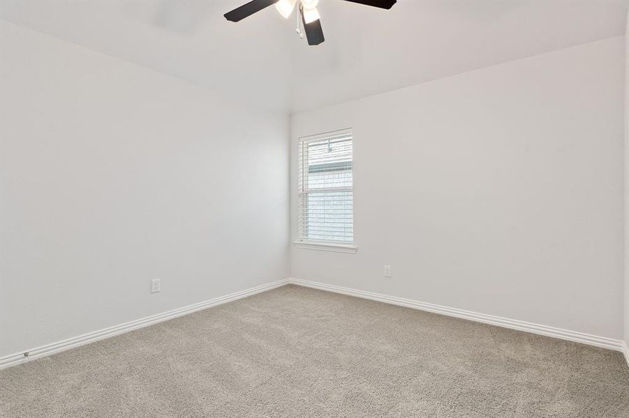 Secondary bedroom featuring ceiling fan