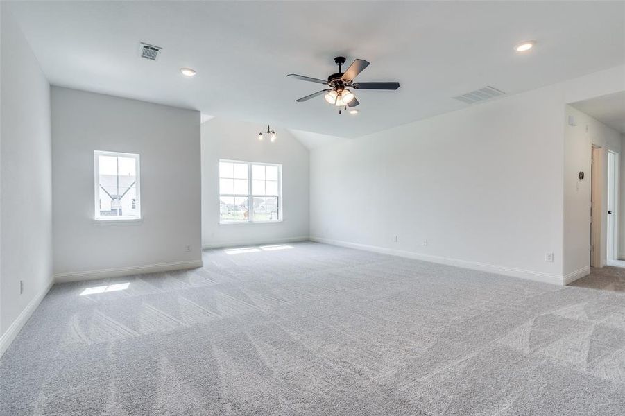 Empty room featuring ceiling fan and light colored carpet