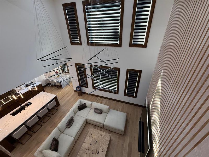 Living room with light wood finished floors and a high ceiling