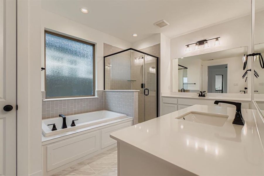Full bath featuring vanity, a garden tub, a shower stall, and recessed lighting Full bath featuring vanity, a garden tub, a shower stall, and recessed lighting