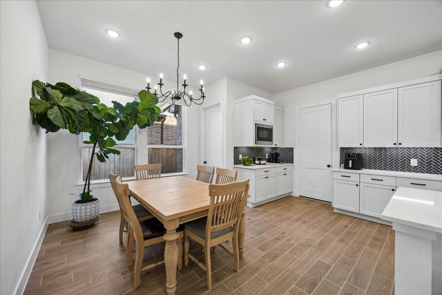 Alternate view of the dining room shows how it connects seamlessly to the kitchen, offering plenty of room for gatherings with a natural flow between rooms. Alternate view of the dining room shows how it connects seamlessly to the kitchen, offering plenty of room for gatherings with a natural flow between rooms.