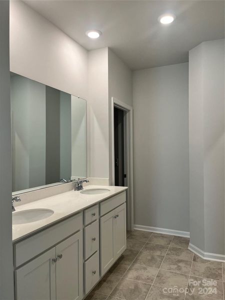 Primary bath with dual vanities and walk-in closet