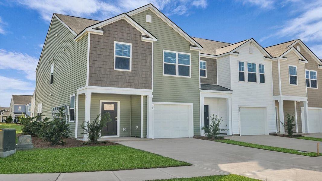 Front exterior of a new home in Carolina Groves Townhomes, Moncks Corner, SC, highlighting curb appeal (Image 2).