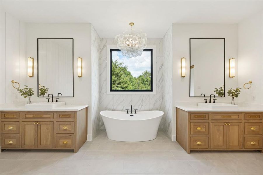 Spa bath featuring a soaking tub and dual white oak vanities. Spa bath featuring a soaking tub and dual white oak vanities.