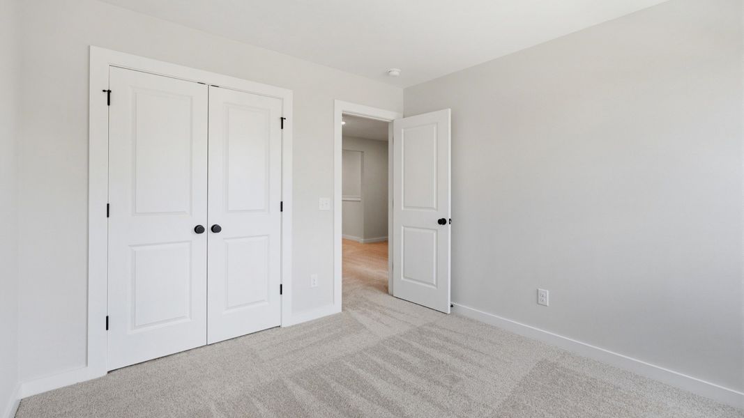 Secondary bedroom with double door closet for storage options