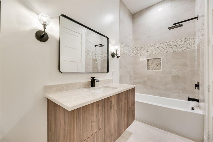 Full bath with vanity, shower combination, and light tile patterned flooring Full bath with vanity, shower combination, and light tile patterned flooring