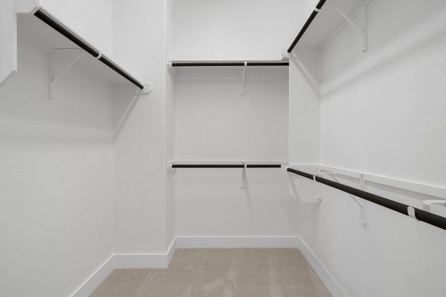 Walk-in closet in Primary Bedroom Walk-in closet in Primary Bedroom