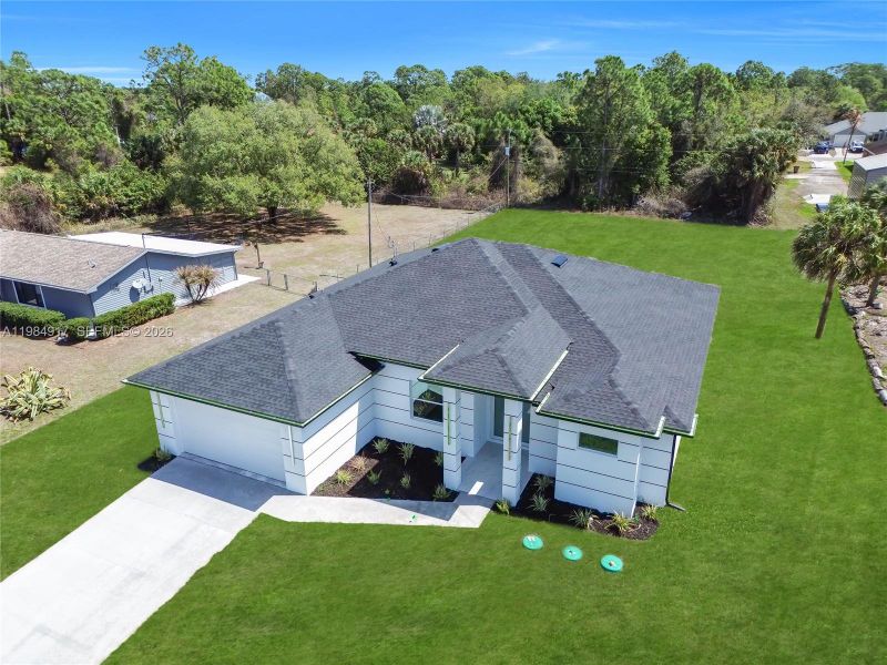 Front exterior of a new home in , Lehigh Acres, FL, highlighting curb appeal (Image 27). Front exterior of a new home in , Lehigh Acres, FL, highlighting curb appeal (Image 27).