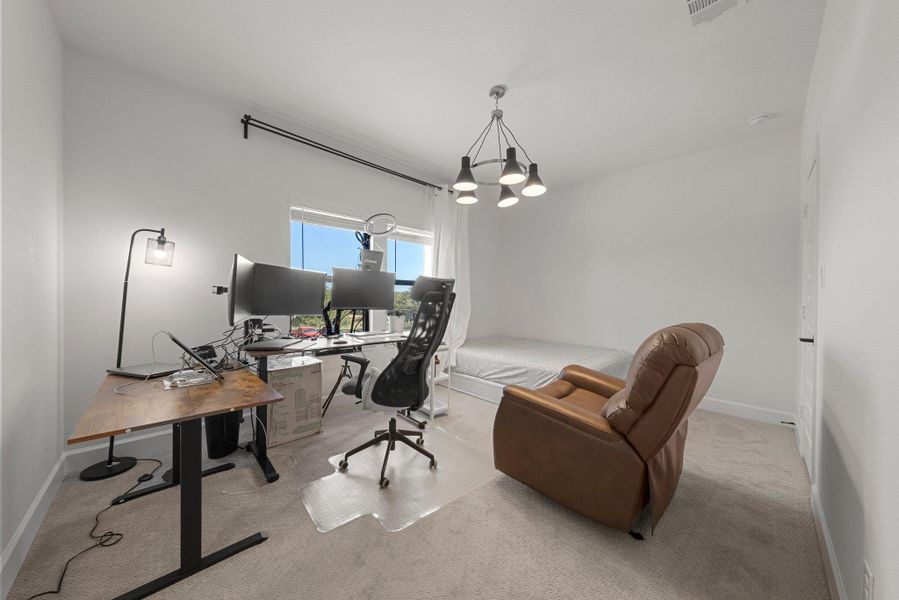 Carpeted home office featuring visible vents and baseboards