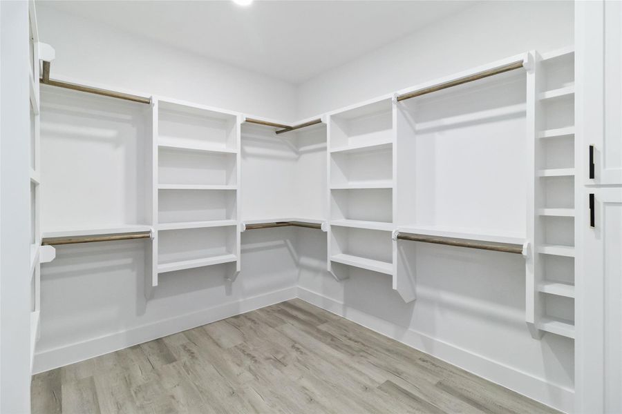 Spacious closet with light wood-style floors