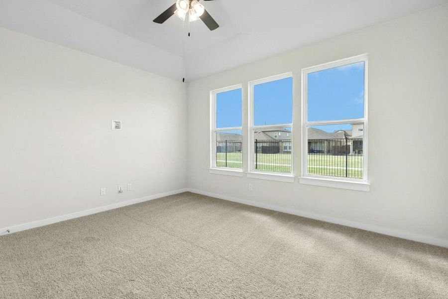 Spare room with carpet floors and a ceiling fan