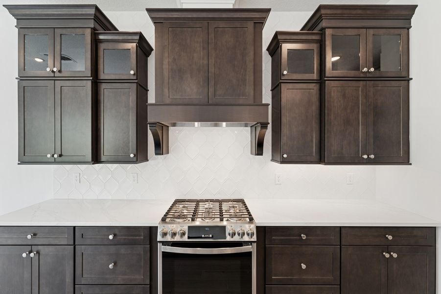 Kitchen with stacked glass-front upper cabinets