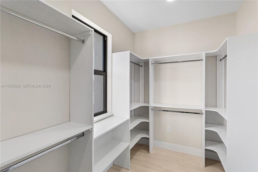 Primary Suite Closet: WALK-IN CLOSET w/ BUILT-IN SHELVING & HANGING RACKS