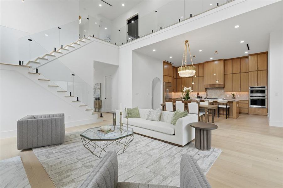 Open-concept living space featuring light wood-finish flooring Open-concept living space featuring light wood-finish flooring