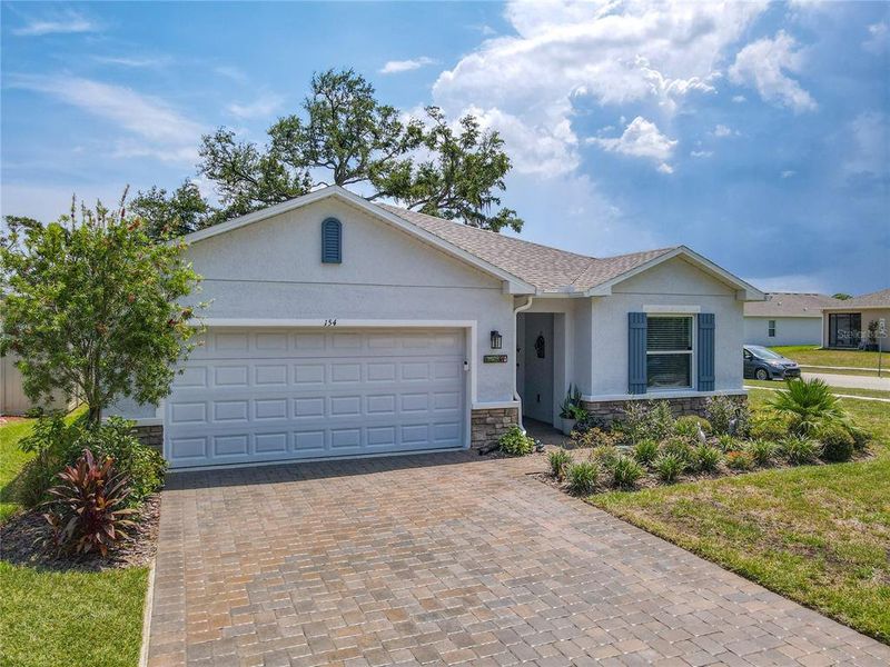 Front exterior of a new home in Riverfront, Edgewater, FL, highlighting curb appeal (Image 24).