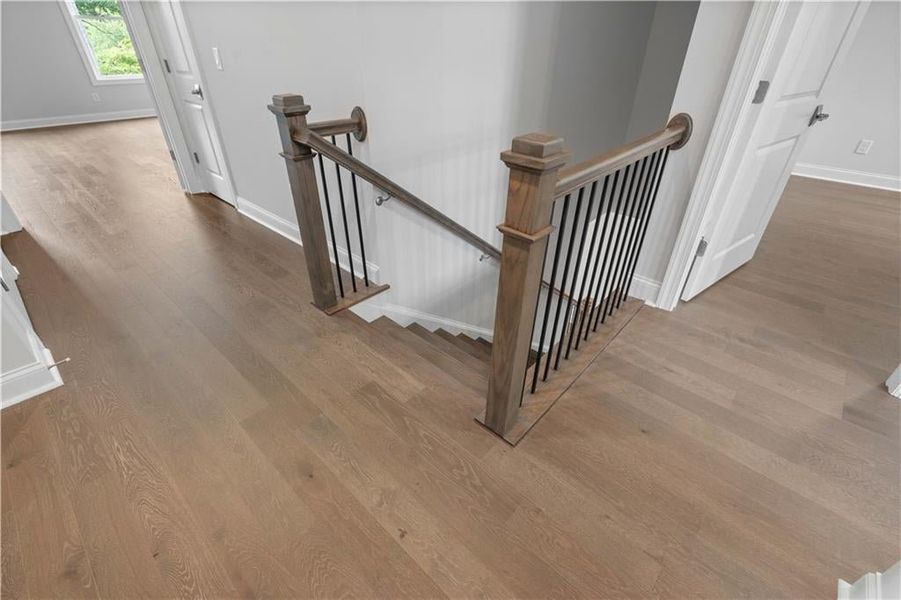 Staircase with wood finished floors and baseboards Staircase with wood finished floors and baseboards