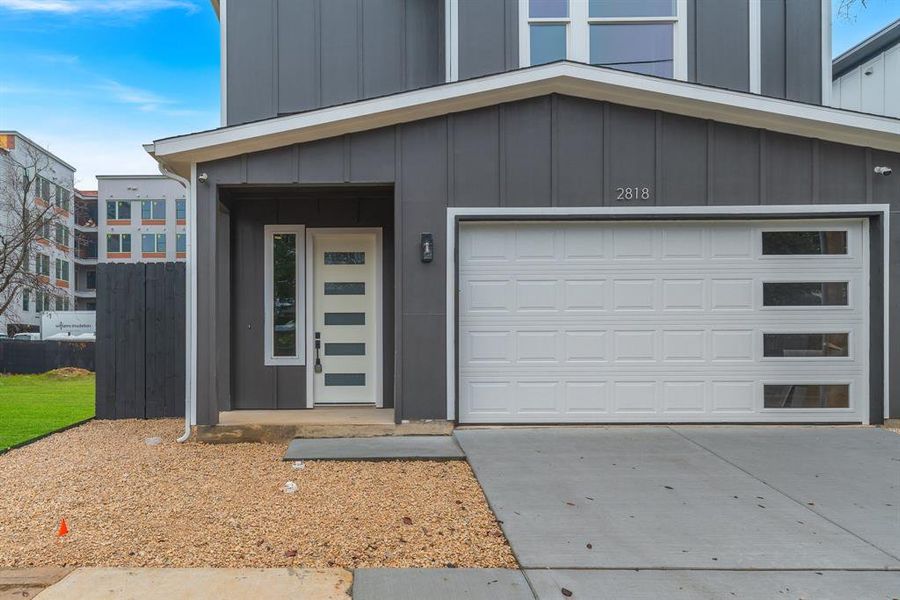 Garage featuring concrete driveway