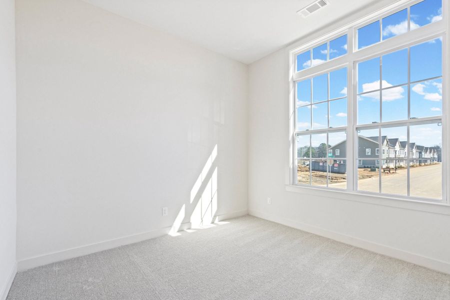 Empty room with baseboards and carpet