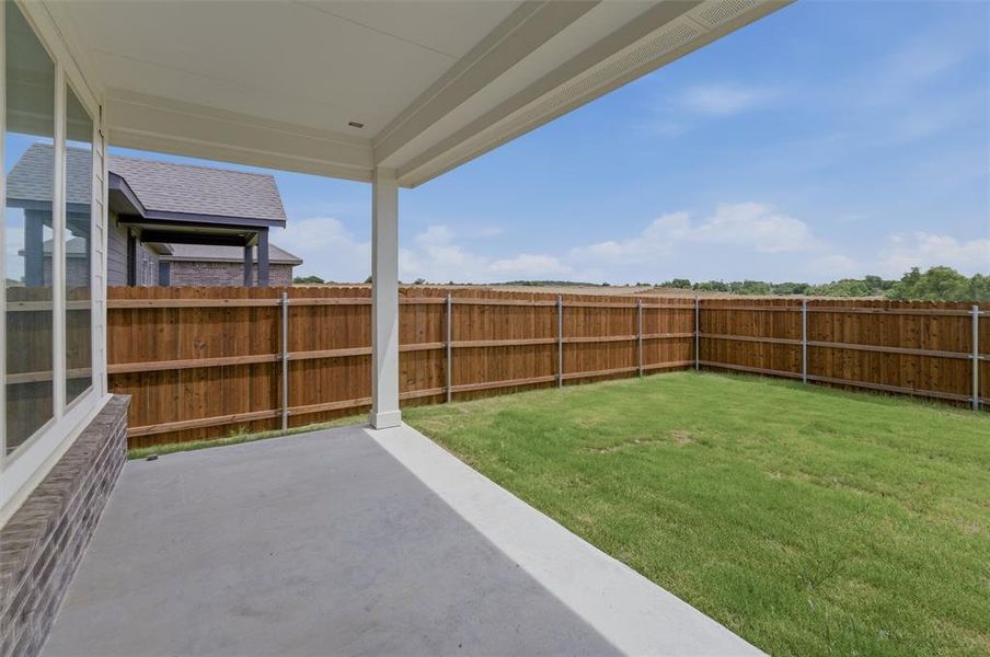 Covered patio featuring a concrete surface and white support columns