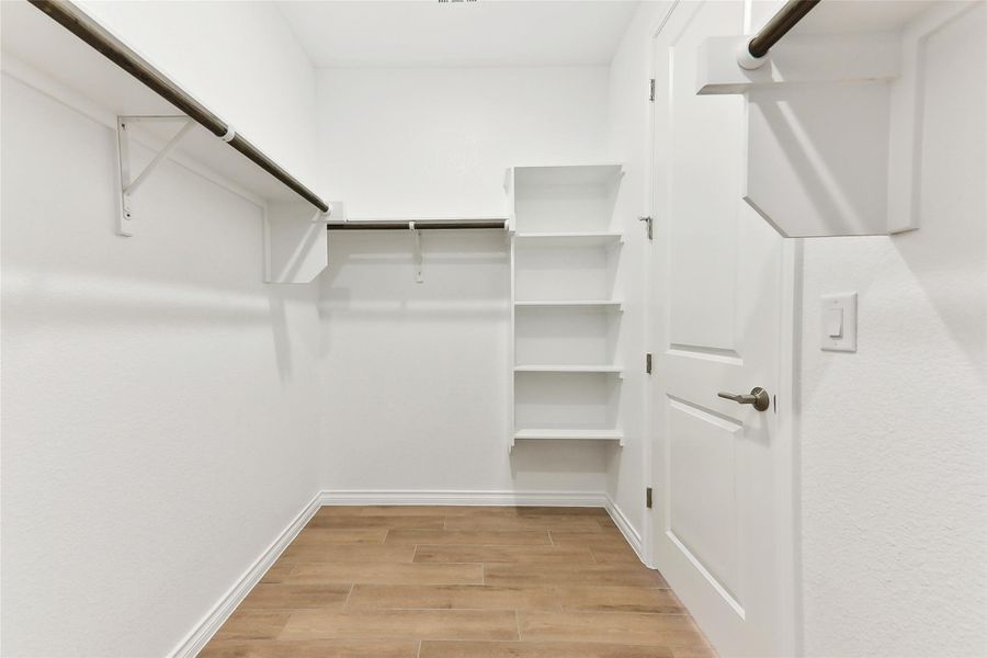 Spacious closet featuring light wood finished floors Spacious closet featuring light wood finished floors
