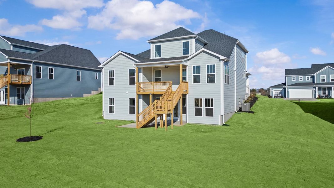 Highly functional rear covered porch adds memorable living space to this elegant home