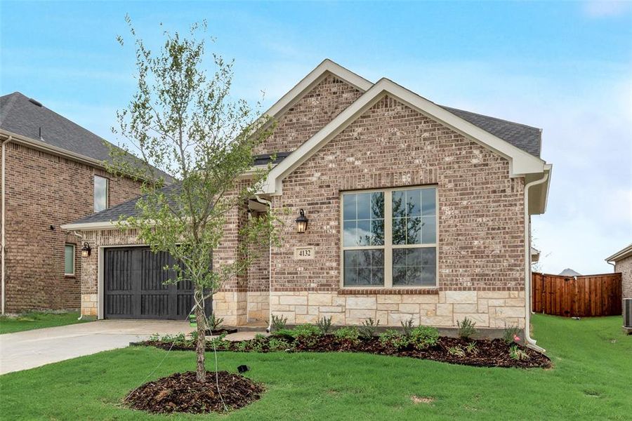 Front exterior of a new home in Spiritas Ranch, Little Elm, TX, highlighting curb appeal (Image 26). Front exterior of a new home in Spiritas Ranch, Little Elm, TX, highlighting curb appeal (Image 26).