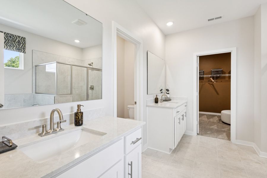 A bathroom with a large mirror. A bathroom with a large mirror.