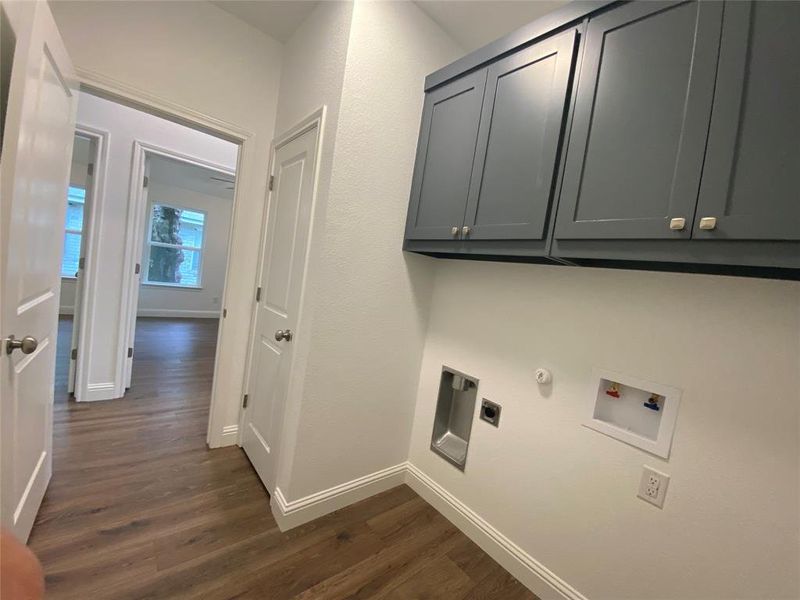 Laundry area with dark wood finished floors, cabinet space, washer hookup, and electric dryer hookup Laundry area with dark wood finished floors, cabinet space, washer hookup, and electric dryer hookup