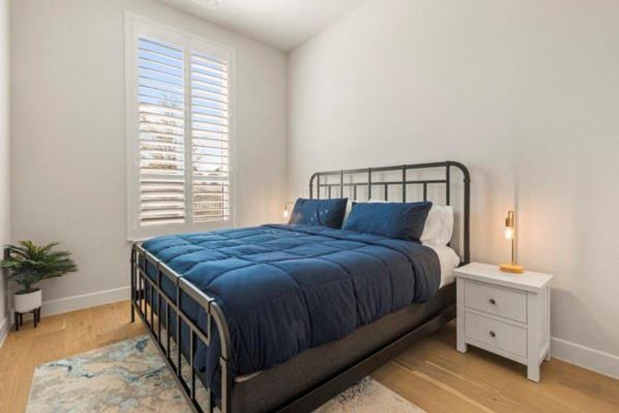 Bedroom with baseboards and light wood finished floors