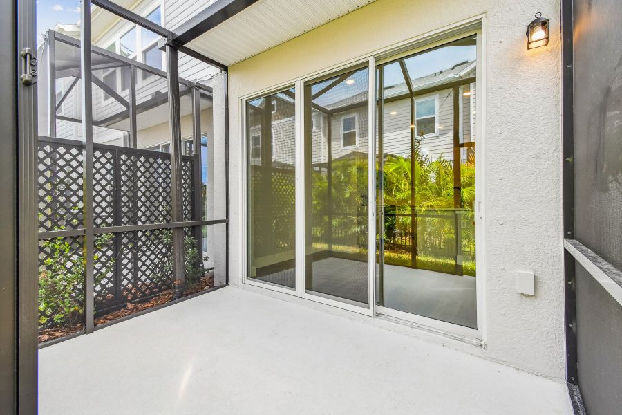 Exterior details and patio area of a home in North River Ranch – Townhomes, Parrish (Image 4).