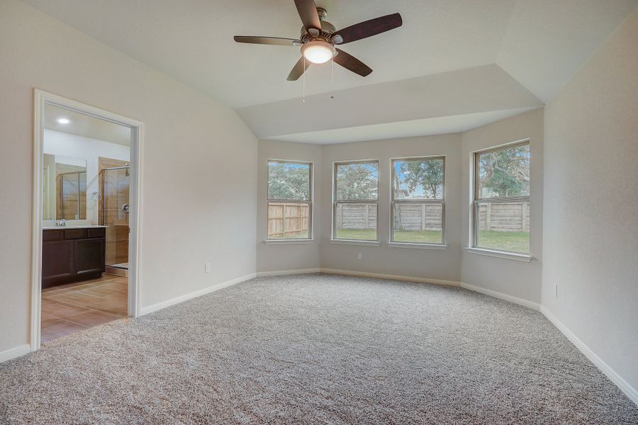 Primary suite bedroom in the Oleander floorplan at a Meritage Homes community.