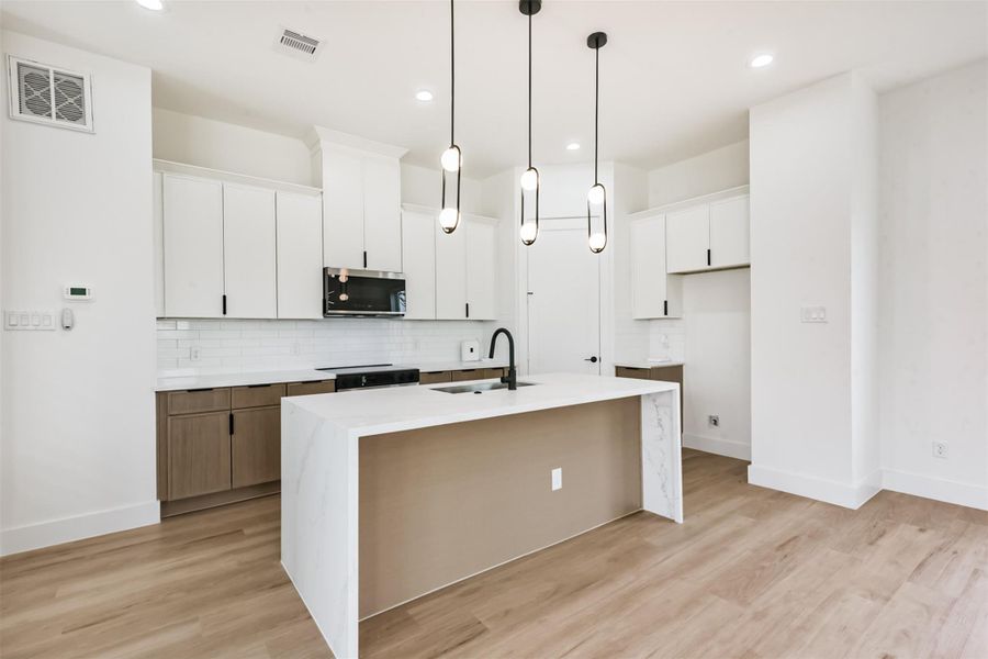 Kitchen island can fit four barstools.