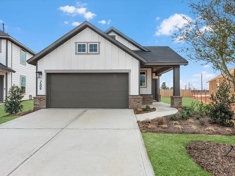 Front exterior of a new home in Mason Woods, Cypress, TX, highlighting curb appeal (Image 1). Front exterior of a new home in Mason Woods, Cypress, TX, highlighting curb appeal (Image 1).
