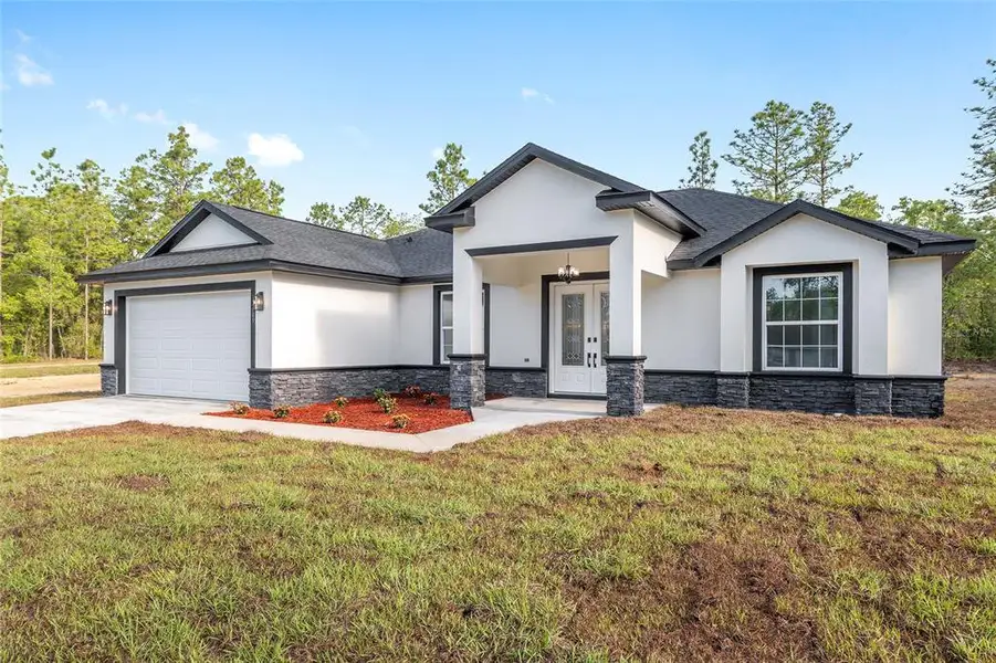 Front exterior of a new home in , Dunnellon, FL, highlighting curb appeal (Image 1).