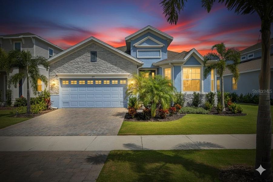 Front exterior of a new home in Marisol Pointe at MiraBay Florida Series, Apollo Beach, FL, highlighting curb appeal (Image 22).