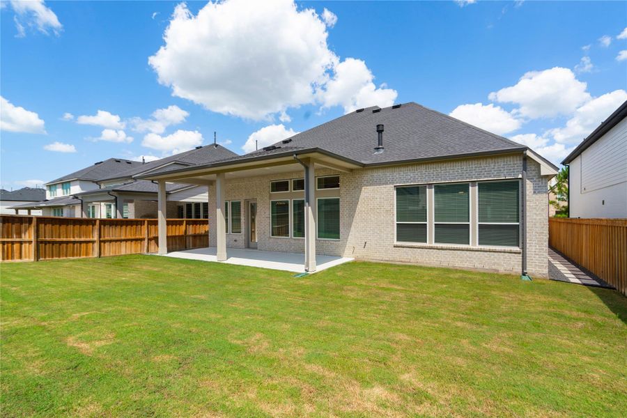 Exterior details and patio area of a home in Woodson’s Reserve, Spring (Image 26).