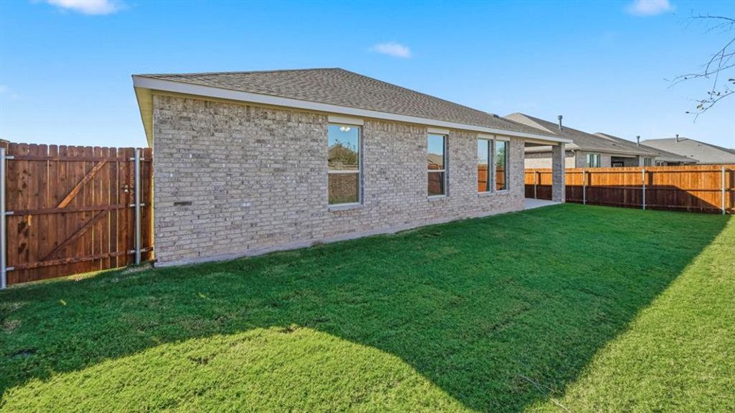 Back of house featuring a patio area, roof with shingles, brick siding, and a fenced backyard Back of house featuring a patio area, roof with shingles, brick siding, and a fenced backyard